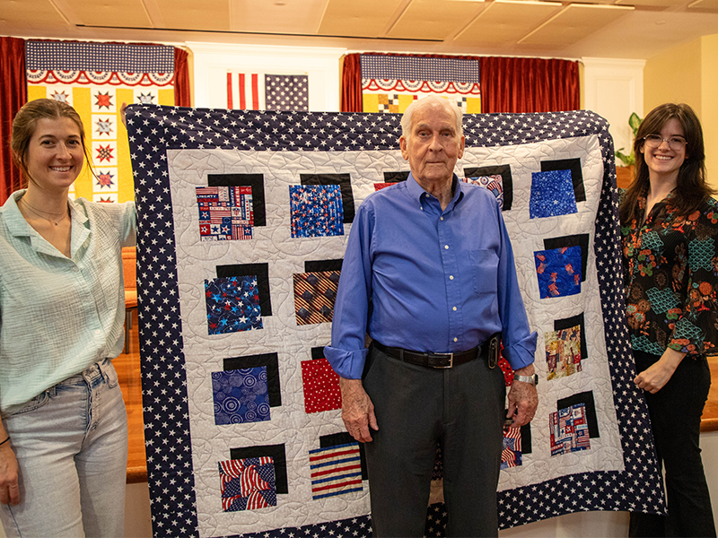 Hank Bradicich and family members pose with his quilt.