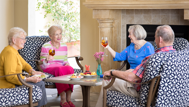 Friends drinking wine together at a retirement community