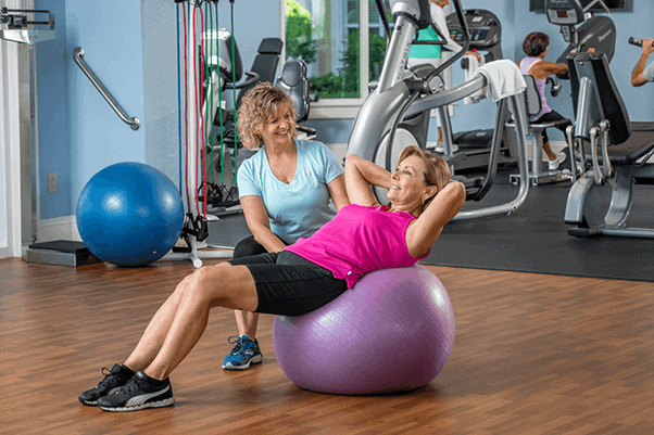 An Acts resident working with a fitness trainer