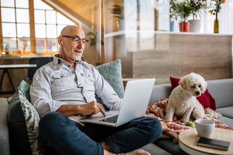 Senior Man Watching Webinar On Laptop