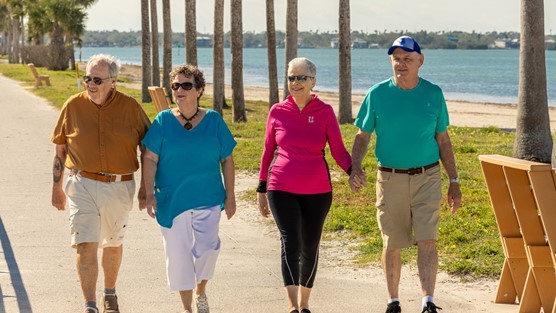 Retirement community residents walking along the water