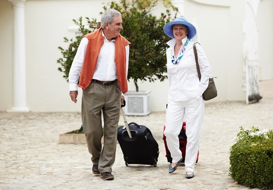 Seniors traveling with packed bags