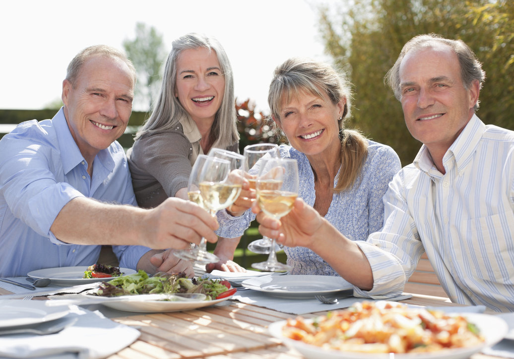 Seniors enjoying dinner together outside