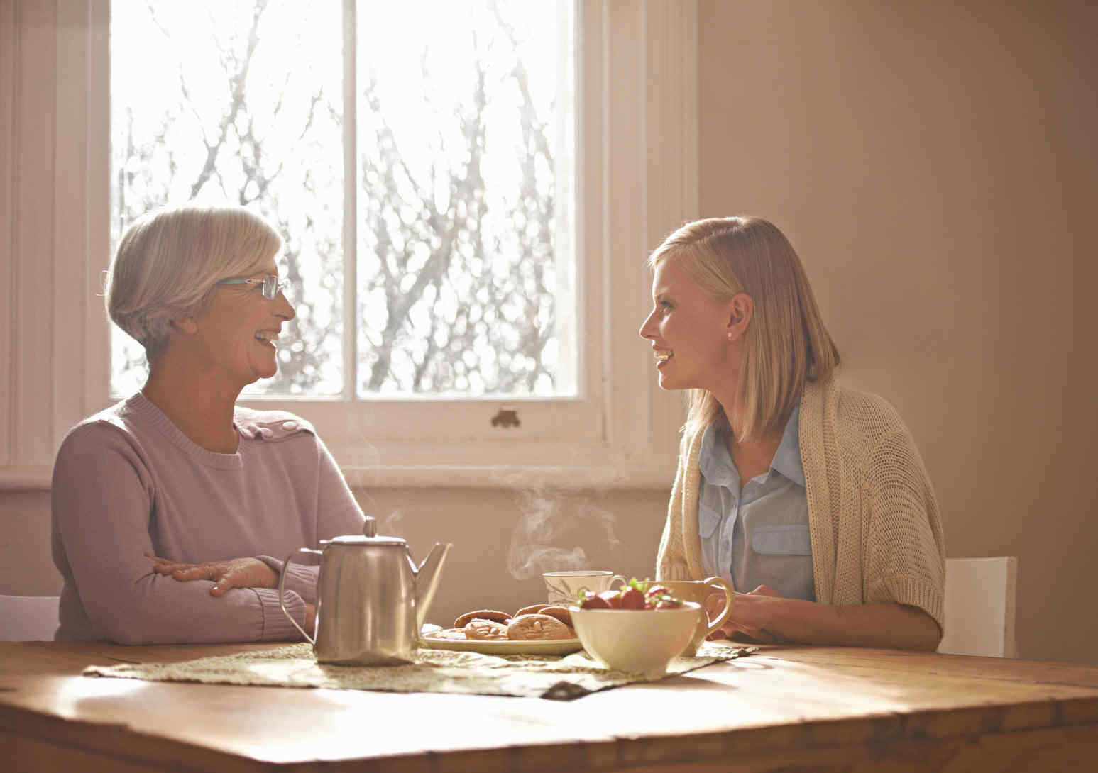 Mother and daughter talking at the kitchen table