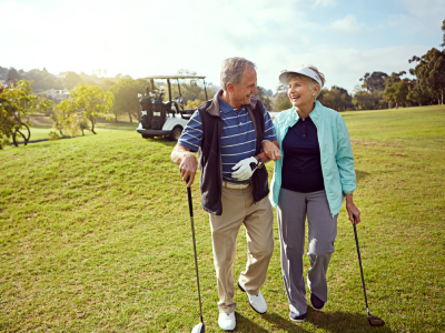 senior couple playing golf