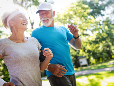 Senior man and woman light jogging outdoors