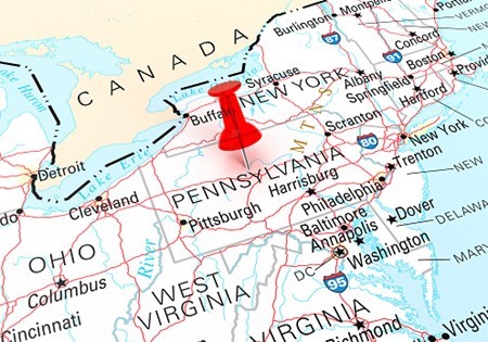 A map of the northeastern United States with a red pushpin marking a location in Pennsylvania, near the border with New York.