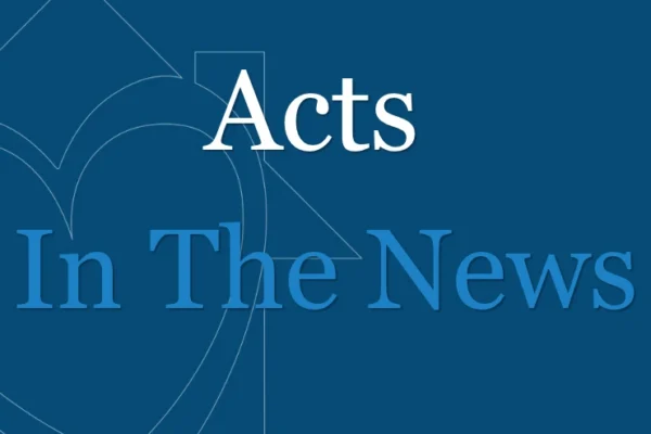 Blue graphic with the text “Acts In The News” in white and blue letters, featuring a faint heart and arrow design in the background.