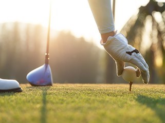 older man playing golf
