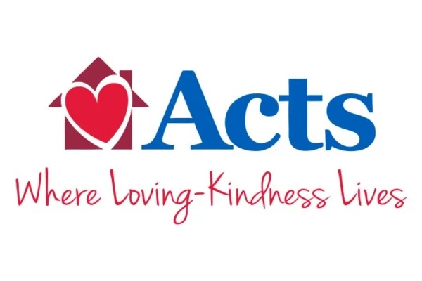 Acts logo with a red house containing a heart, blue text “Acts,” and red script below reading “Where Loving-Kindness Lives.”.